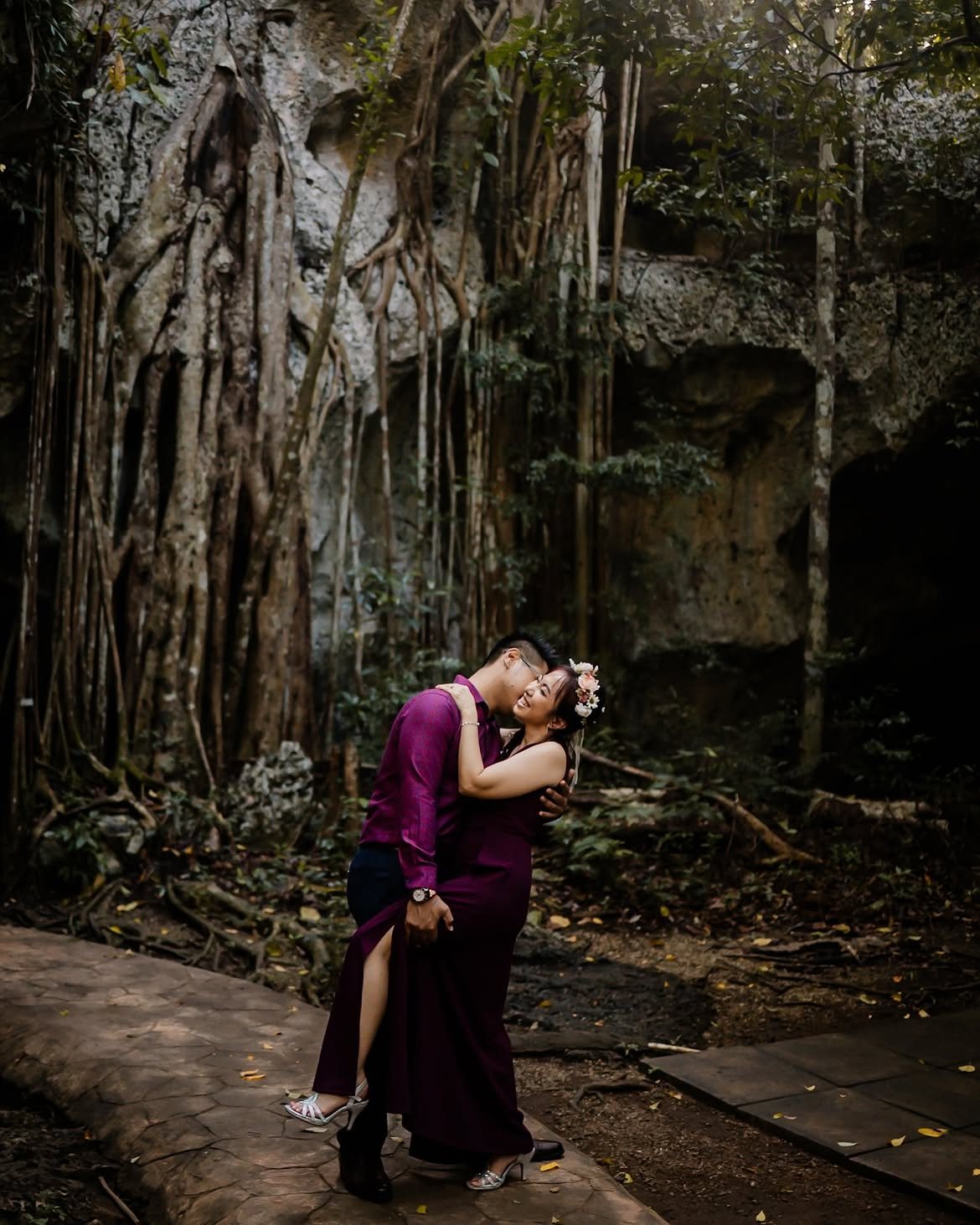Couple embracing in a Jamaican forest, photographed by Snap Gen Studios