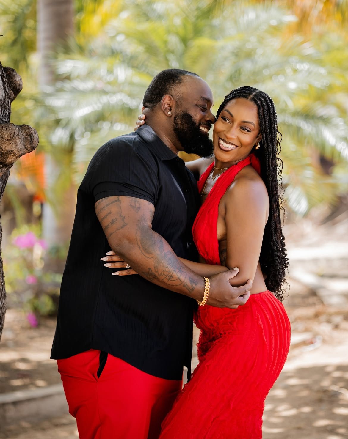 Couple in red embracing, photographed by Snap Gen Studios